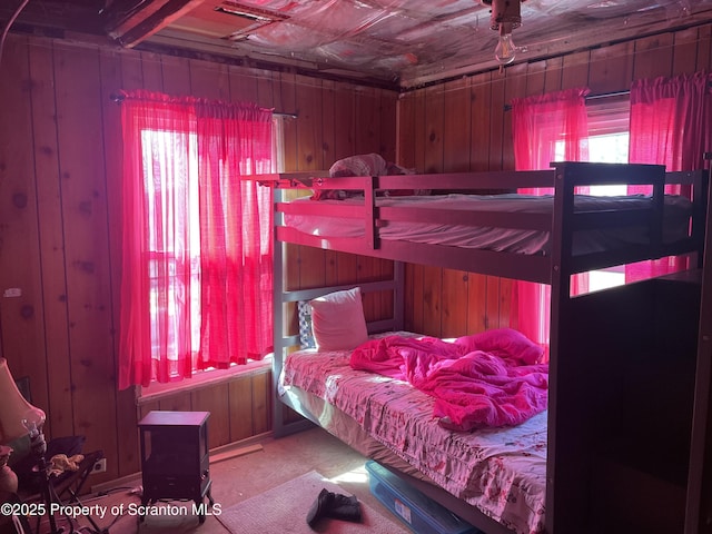 bedroom featuring wood walls and an ornate ceiling