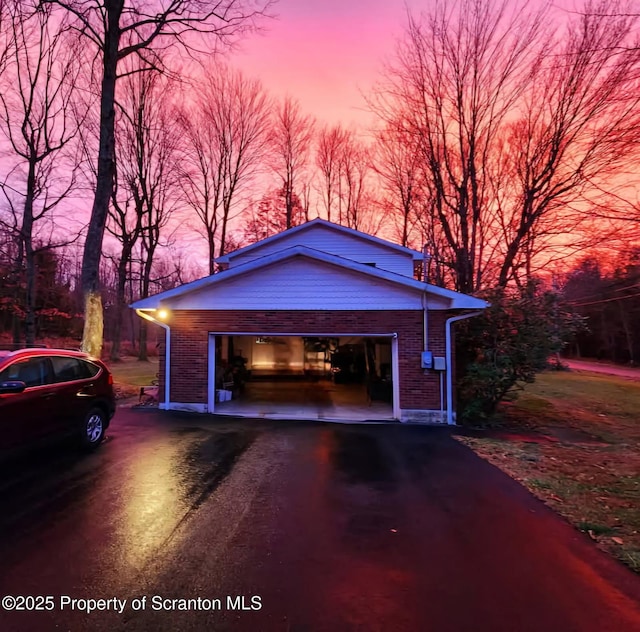 410 Lake Spangenberg Rd, Jefferson Twp, PA 18436 - garage at dusk with asphalt driveway