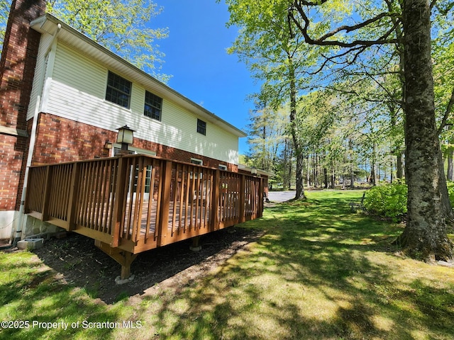 410 Lake Spangenberg Rd, Jefferson Twp, PA 18436 - rear view of house featuring a yard, brick siding, and a wooden deck