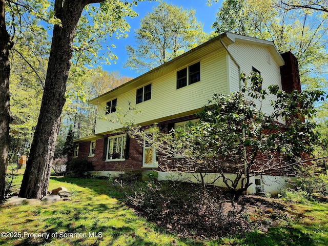 410 Lake Spangenberg Rd, Jefferson Twp, PA 18436 - view of front of home featuring brick siding and a front lawn