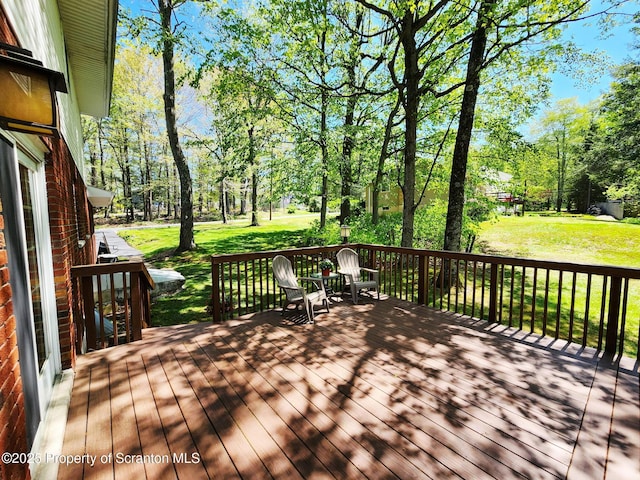 410 Lake Spangenberg Rd, Jefferson Twp, PA 18436 - wooden terrace featuring a yard and view of scattered trees