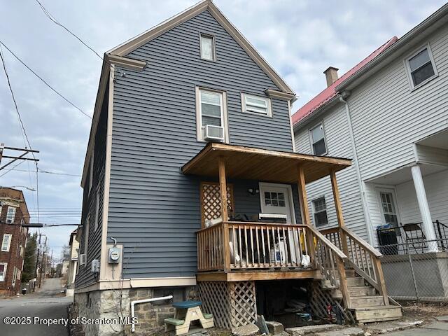 rear view of property featuring cooling unit