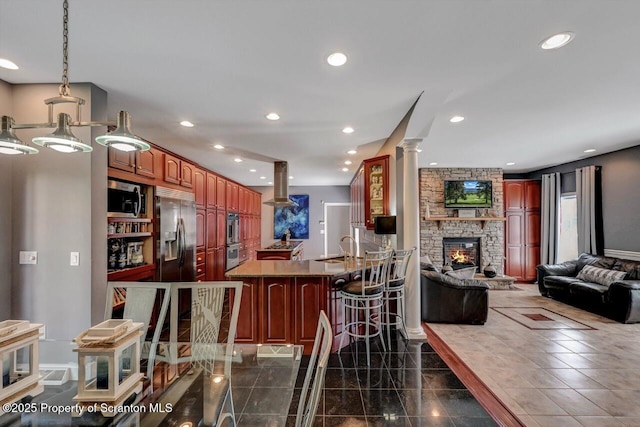 1015 Circle Green Dr Unit L 25, South Abington Twp, PA 18411 - kitchen featuring island range hood, stainless steel appliances, open floor plan, a peninsula, and a kitchen bar