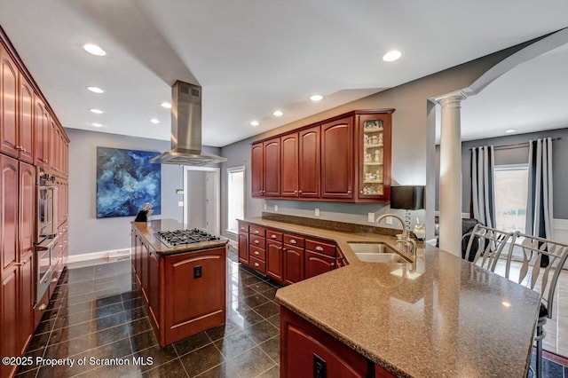1015 Circle Green Dr Unit L 25, South Abington Twp, PA 18411 - kitchen featuring island range hood, a sink, ornate columns, stainless steel gas cooktop, and a center island