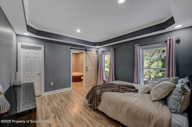1015 Circle Green Dr Unit L 25, South Abington Twp, PA 18411 - bedroom featuring wood finished floors, a tray ceiling, a barn door, baseboards, and recessed lighting