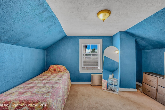 115 Marion St, Old Forge, PA 18518 - carpeted bedroom featuring radiator heating unit, a textured ceiling, vaulted ceiling, baseboards, and a textured wall