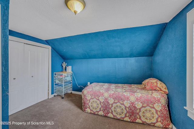 115 Marion St, Old Forge, PA 18518 - bedroom with lofted ceiling, carpet floors, baseboards, a textured ceiling, and a closet