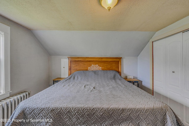 115 Marion St, Old Forge, PA 18518 - bedroom featuring radiator, lofted ceiling, a textured ceiling, and a closet