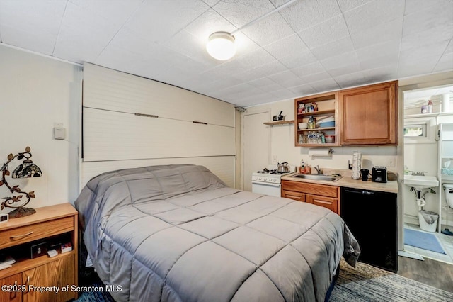 bedroom featuring sink and dark hardwood / wood-style floors