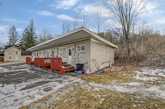 rear view of property featuring a deck