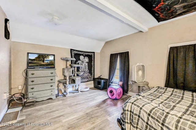 bedroom with wood-type flooring and lofted ceiling with beams