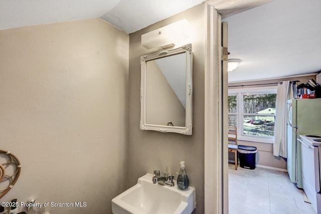 bathroom with sink and vaulted ceiling