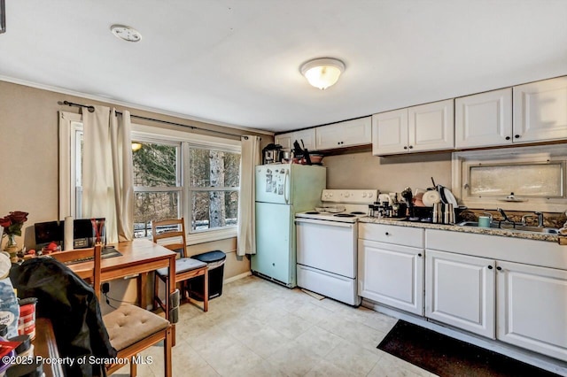 kitchen featuring sink, white appliances, white cabinets, and light stone counters