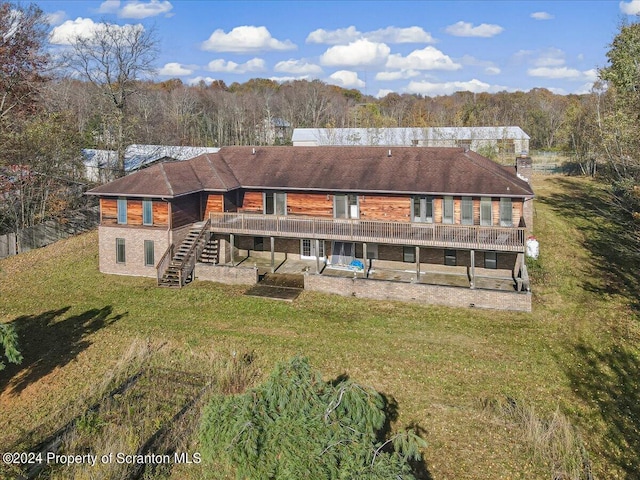 rear view of house featuring a patio area, a yard, and a deck