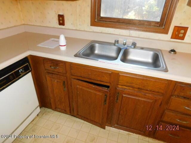 kitchen with white dishwasher and sink