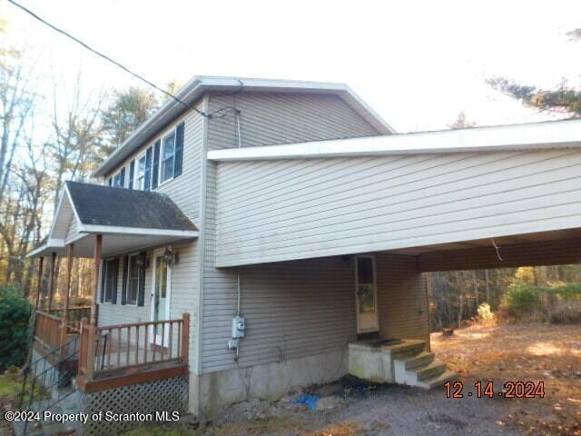 view of front of home featuring a carport