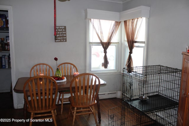 dining room featuring baseboard heating and wood finished floors