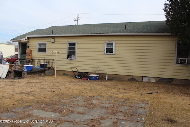 back of house featuring crawl space, central air condition unit, cooling unit, and roof with shingles