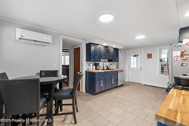 kitchen with blue cabinets, butcher block countertops, sink, an AC wall unit, and stainless steel appliances