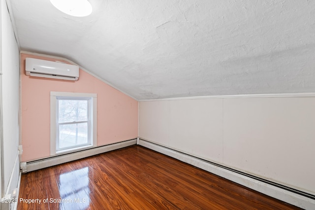 bonus room with vaulted ceiling, hardwood / wood-style floors, a wall unit AC, a textured ceiling, and a baseboard radiator