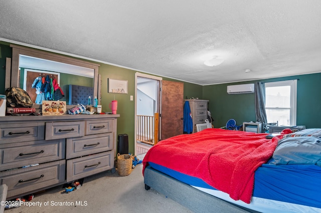 bedroom featuring a wall mounted air conditioner and a textured ceiling