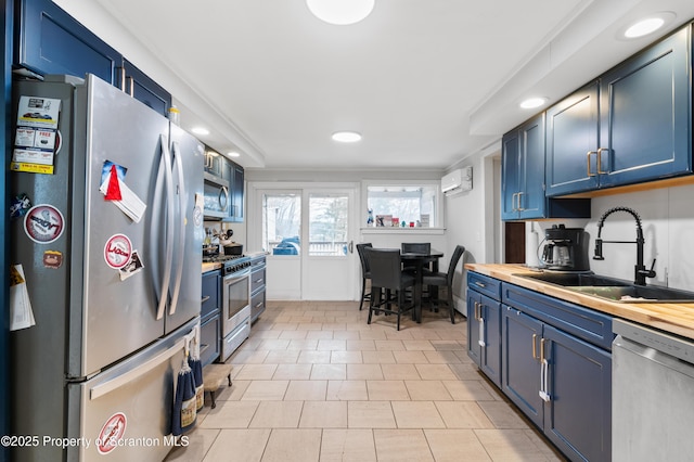 kitchen featuring sink, stainless steel appliances, and blue cabinets