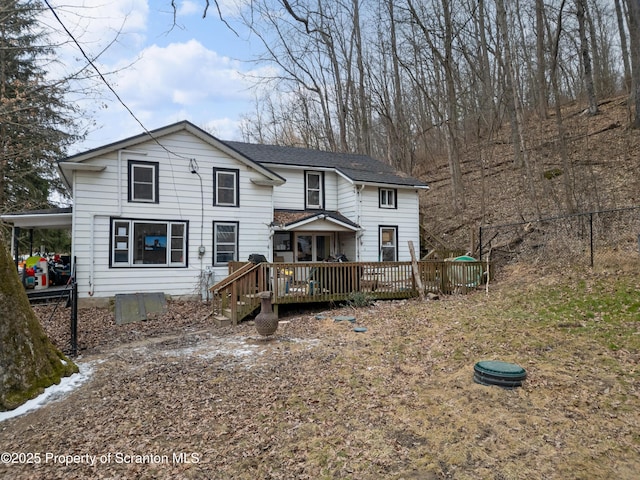 rear view of property featuring a deck