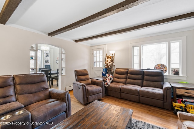 living room featuring beamed ceiling, a baseboard radiator, a notable chandelier, and light wood-type flooring