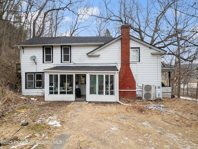 rear view of property with a sunroom and ac unit