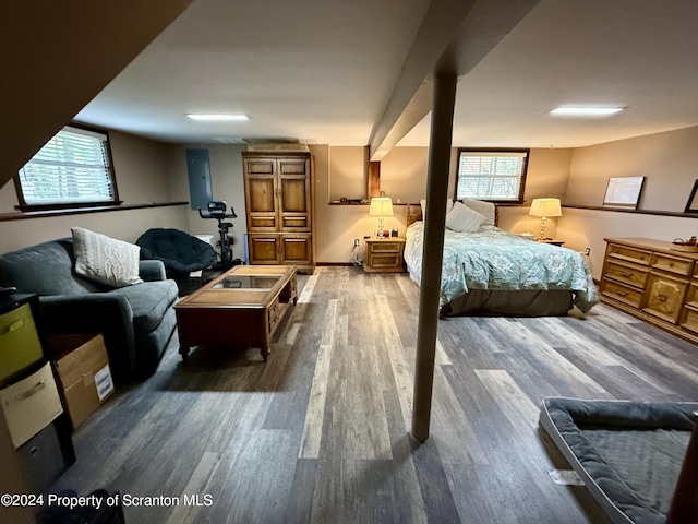 bedroom with wood-type flooring and multiple windows