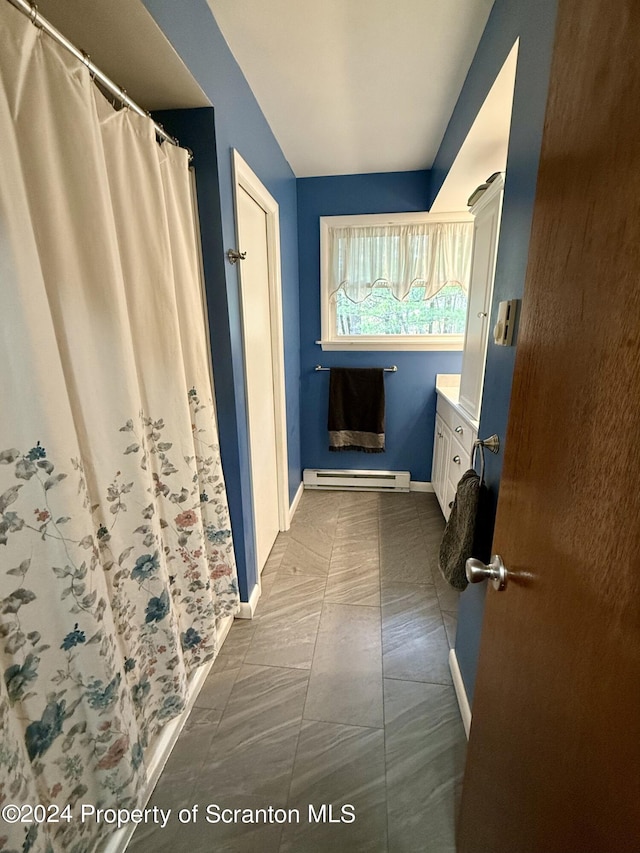 bathroom with vanity and baseboard heating