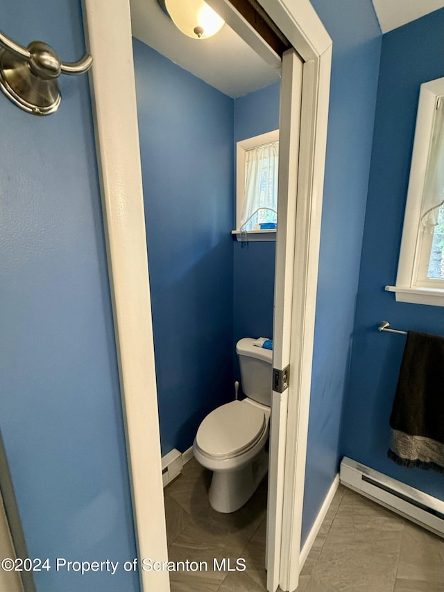 bathroom featuring tile patterned floors, toilet, and baseboard heating