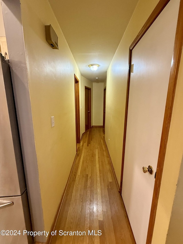 hallway with light hardwood / wood-style floors