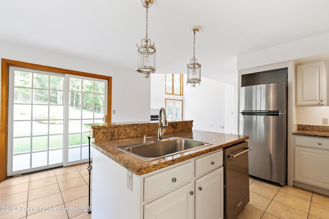 kitchen featuring white cabinetry, sink, an island with sink, pendant lighting, and appliances with stainless steel finishes