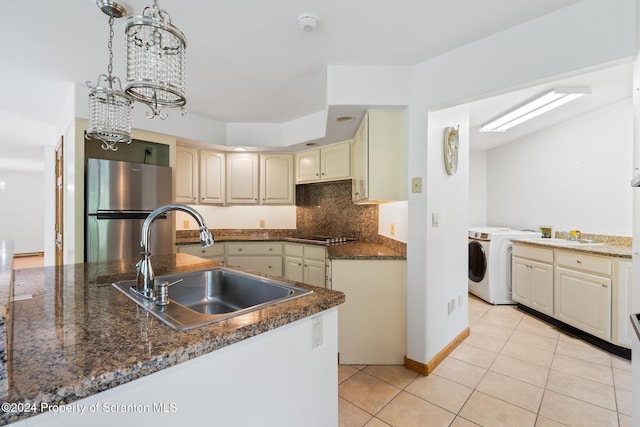 133 Glenmaura Dr, Moosic, PA 18507 - kitchen with freestanding refrigerator, a sink, light tile patterned floors, a chandelier, and backsplash