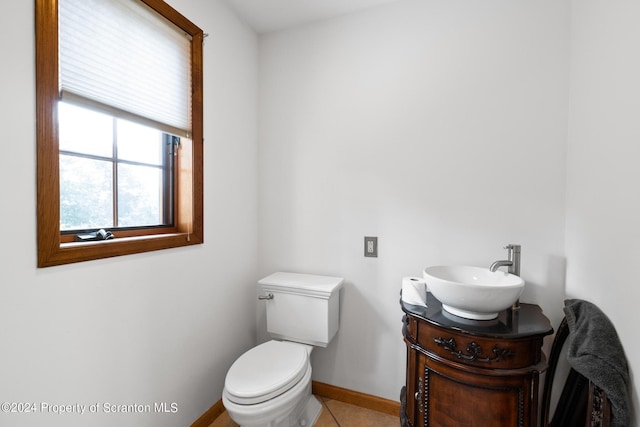 bathroom featuring tile patterned floors, vanity, and toilet