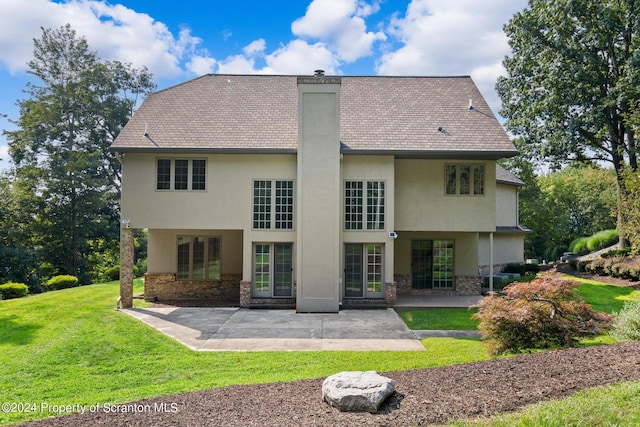 133 Glenmaura Dr, Moosic, PA 18507 - rear view of house with stucco siding, a lawn, a chimney, a patio, and stone siding