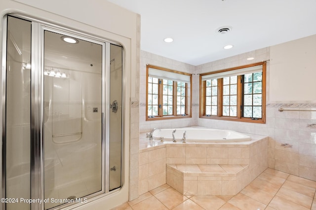 bathroom featuring tile patterned floors, tile walls, and independent shower and bath