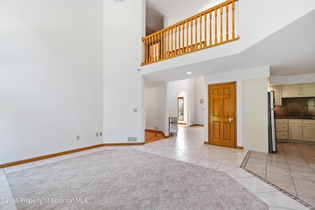 unfurnished living room featuring light tile patterned flooring