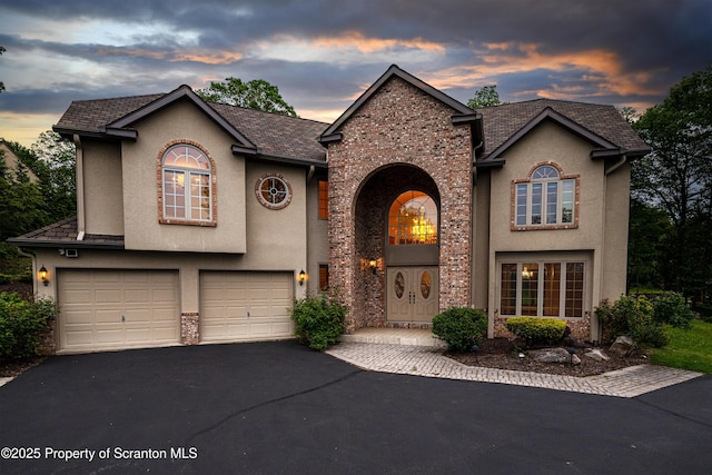 133 Glenmaura Dr, Moosic, PA 18507 - view of front of property with stucco siding, driveway, and a garage