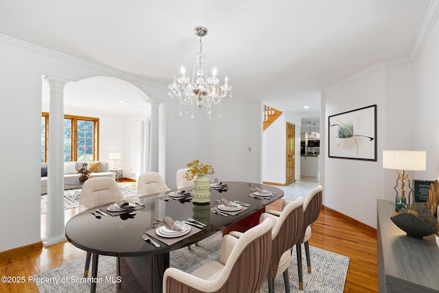 133 Glenmaura Dr, Moosic, PA 18507 - dining area with ornate columns, crown molding, light wood finished floors, baseboards, and arched walkways