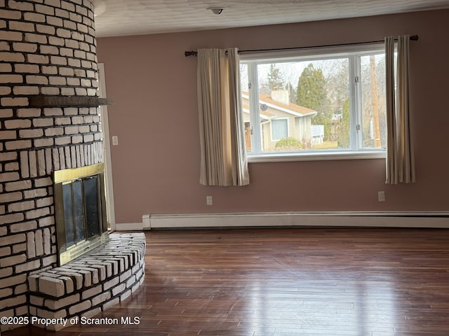 interior space featuring baseboard heating, a fireplace, and wood finished floors