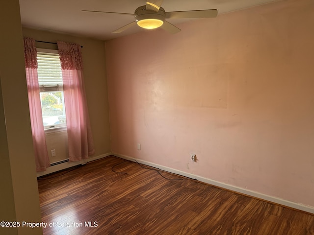 spare room with ceiling fan, baseboards, and wood finished floors