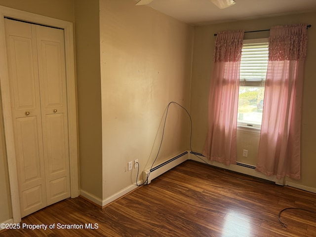 unfurnished bedroom with dark wood-style floors and baseboards