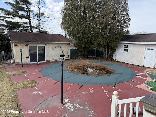 view of swimming pool featuring a patio area, an outdoor structure, and fence