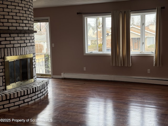 unfurnished living room with a brick fireplace, wood finished floors, baseboards, and baseboard heating