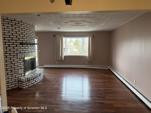 unfurnished living room featuring a textured ceiling, wood finished floors, a fireplace, a baseboard radiator, and baseboard heating