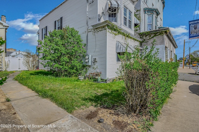 view of home's exterior featuring fence and a gate