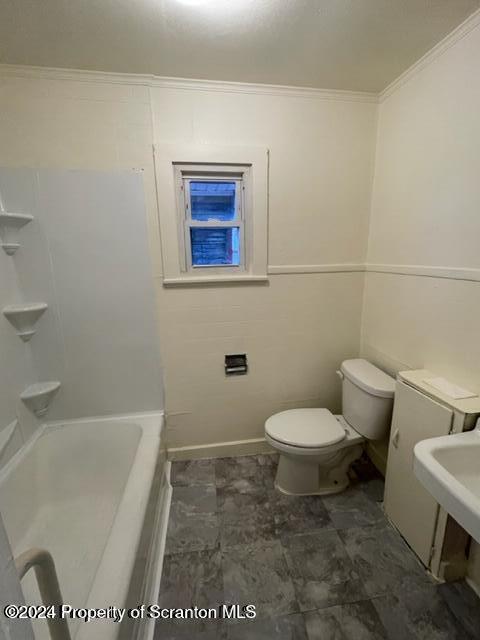 bathroom with toilet, ornamental molding, and sink