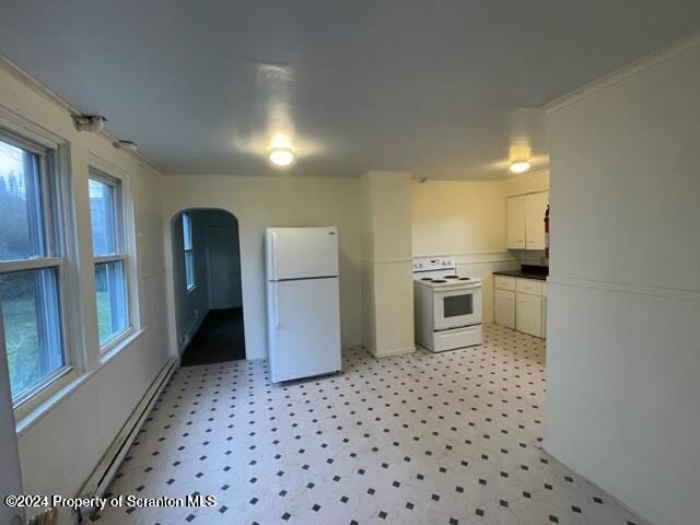 kitchen featuring white cabinets, a healthy amount of sunlight, white appliances, and a baseboard heating unit